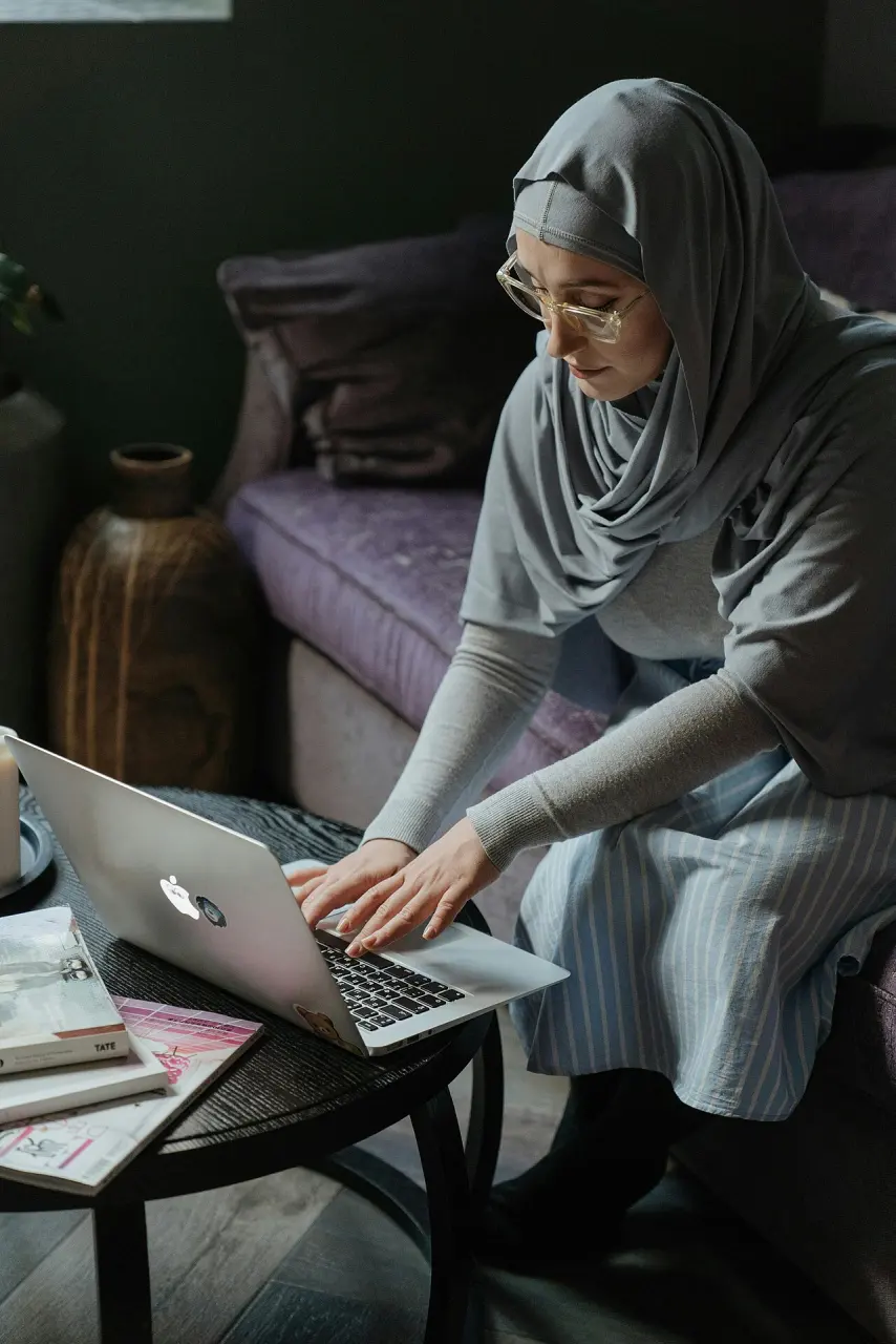 Adult woman using a laptop while relaxing at home
