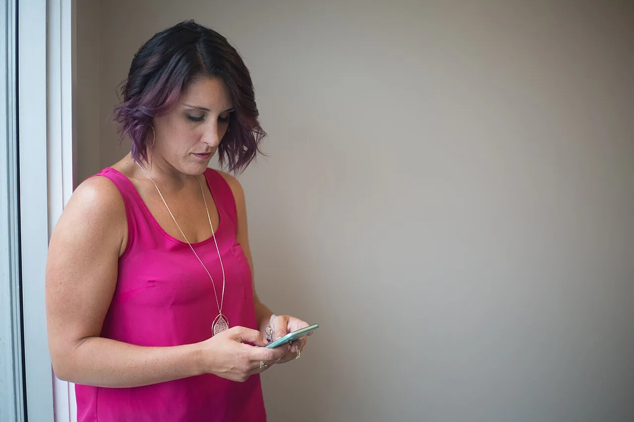 Adult woman using a smartphone to compare online dating choices