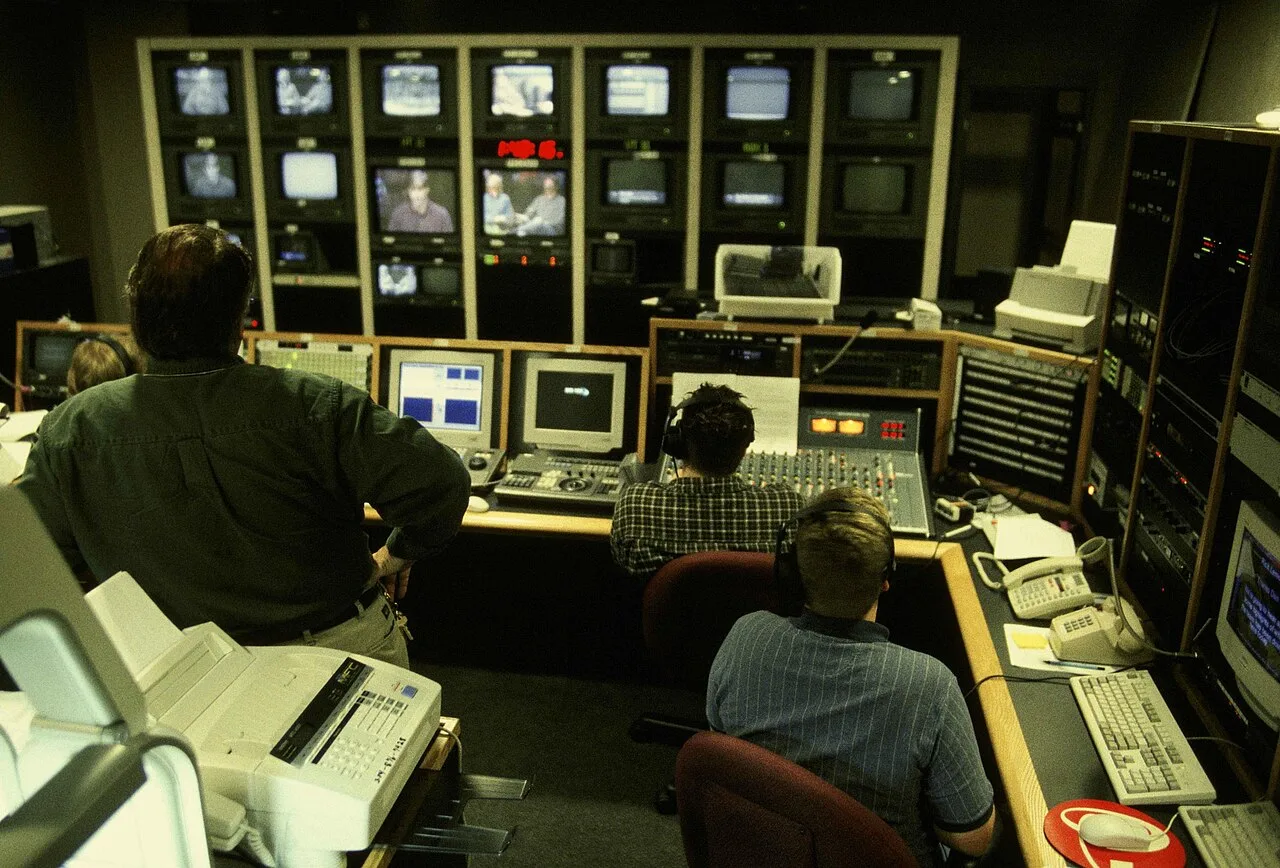 Video production workers checking several live camera feeds